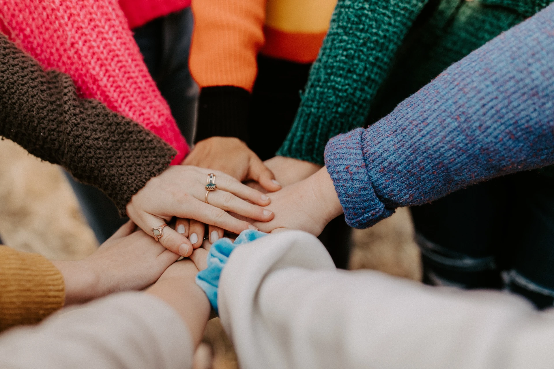 girl friends hands piled togethger - Hannah Busing